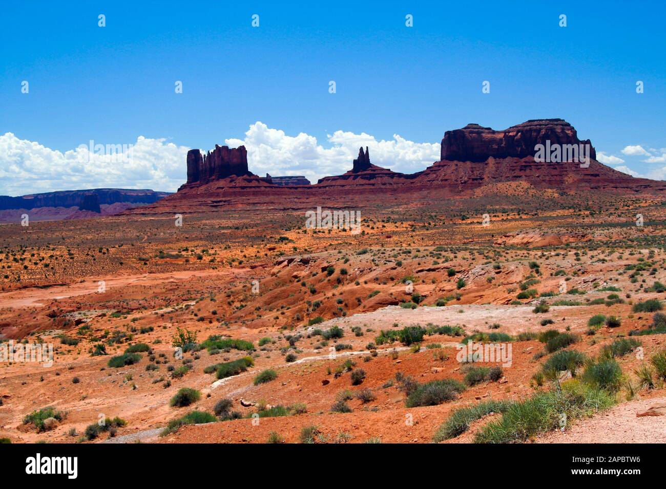 Butte Sand View over red sand dry waste land with green grass tufts on sandstone ...