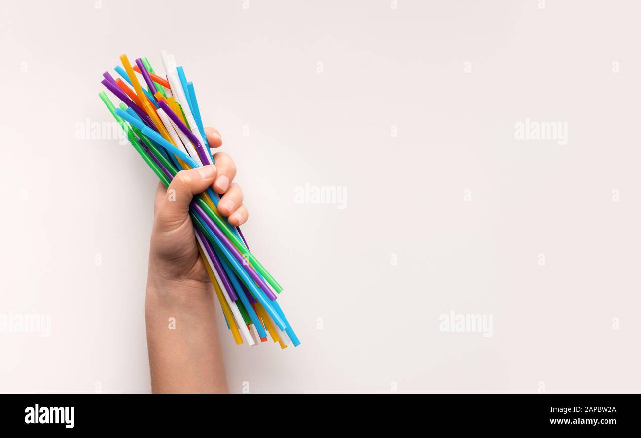 Hand holding heap of used plastic straws on white Stock Photo Alamy