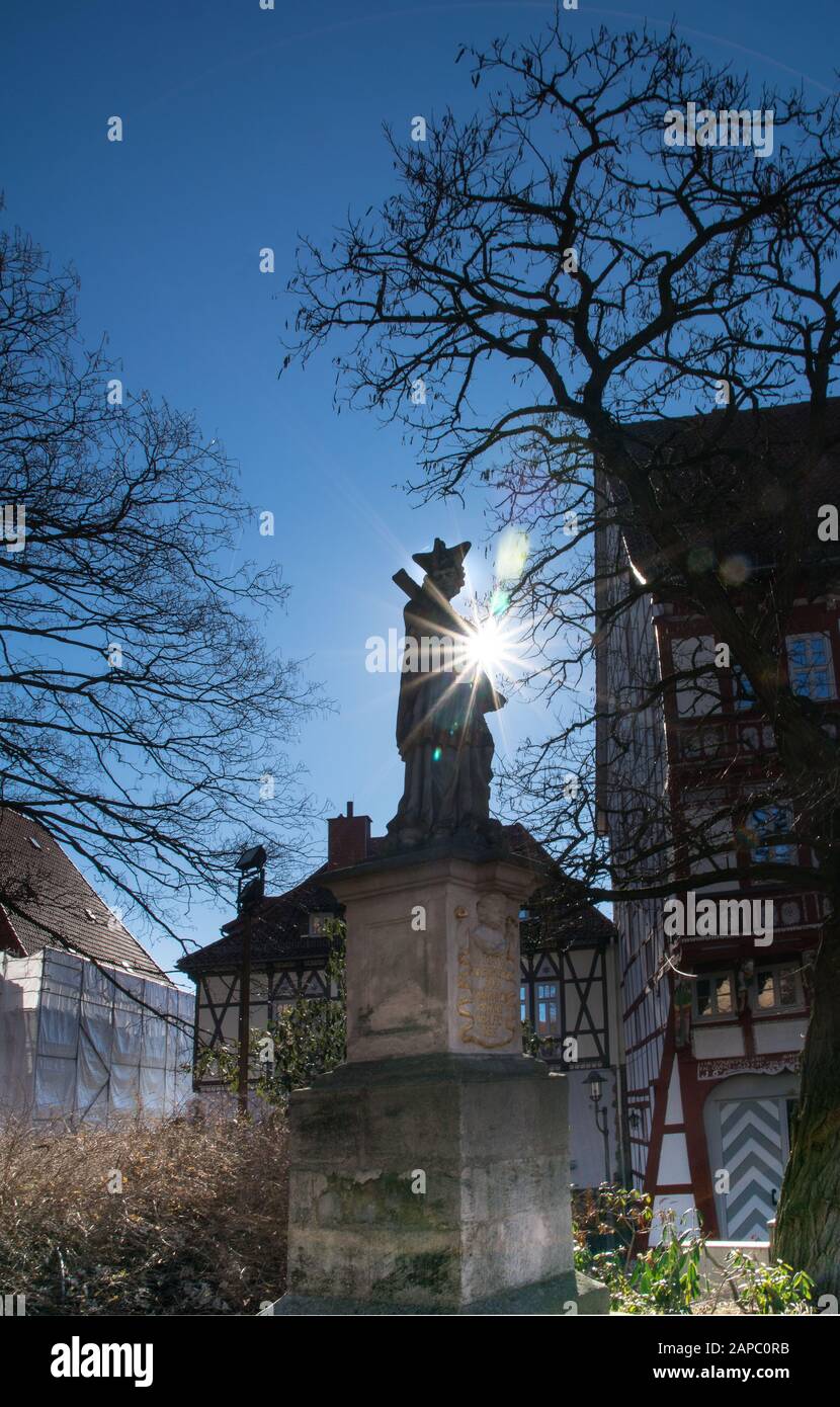 Monument with figure and lens flare in the german city duderstadt Stock Photo