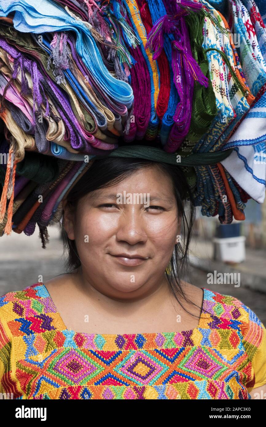 Central America, El Salvador, Ataco. A Mayan woman carrying clothing to market for sale Stock Photo
