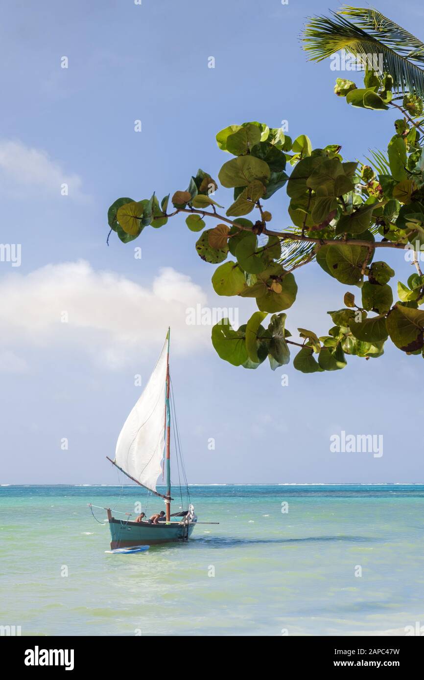 Central America, Nicaragua, Little Corn Island. A traditional Caribbean wooden sail boat on turquoise sea. Stock Photo