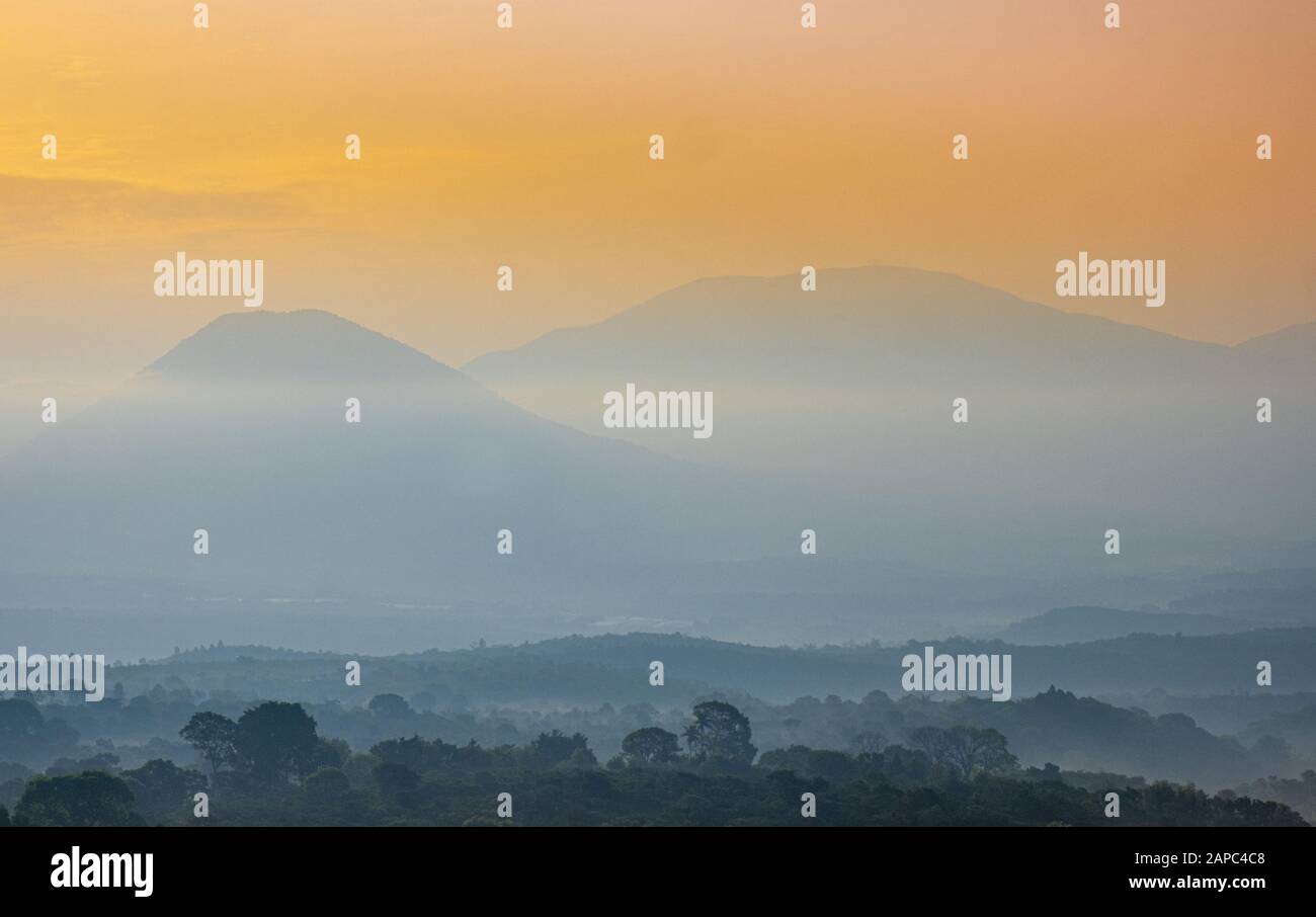 Central America, El Salvador. Sunset view of volcanic peaks in central El Salvador including the cones of Cerro Verde national park Stock Photo