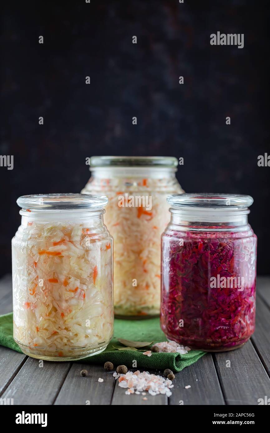 glass jars of fermented white, red cabbage, spices, salt. vegetables on