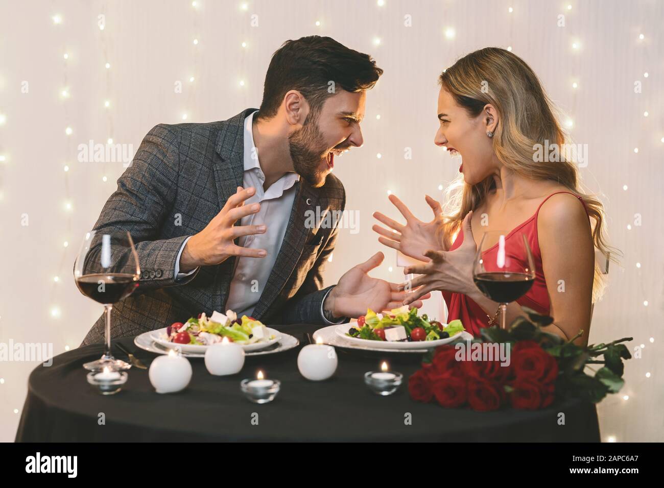 Angry couple arguing during romantic dinner in restaurant Stock Photo