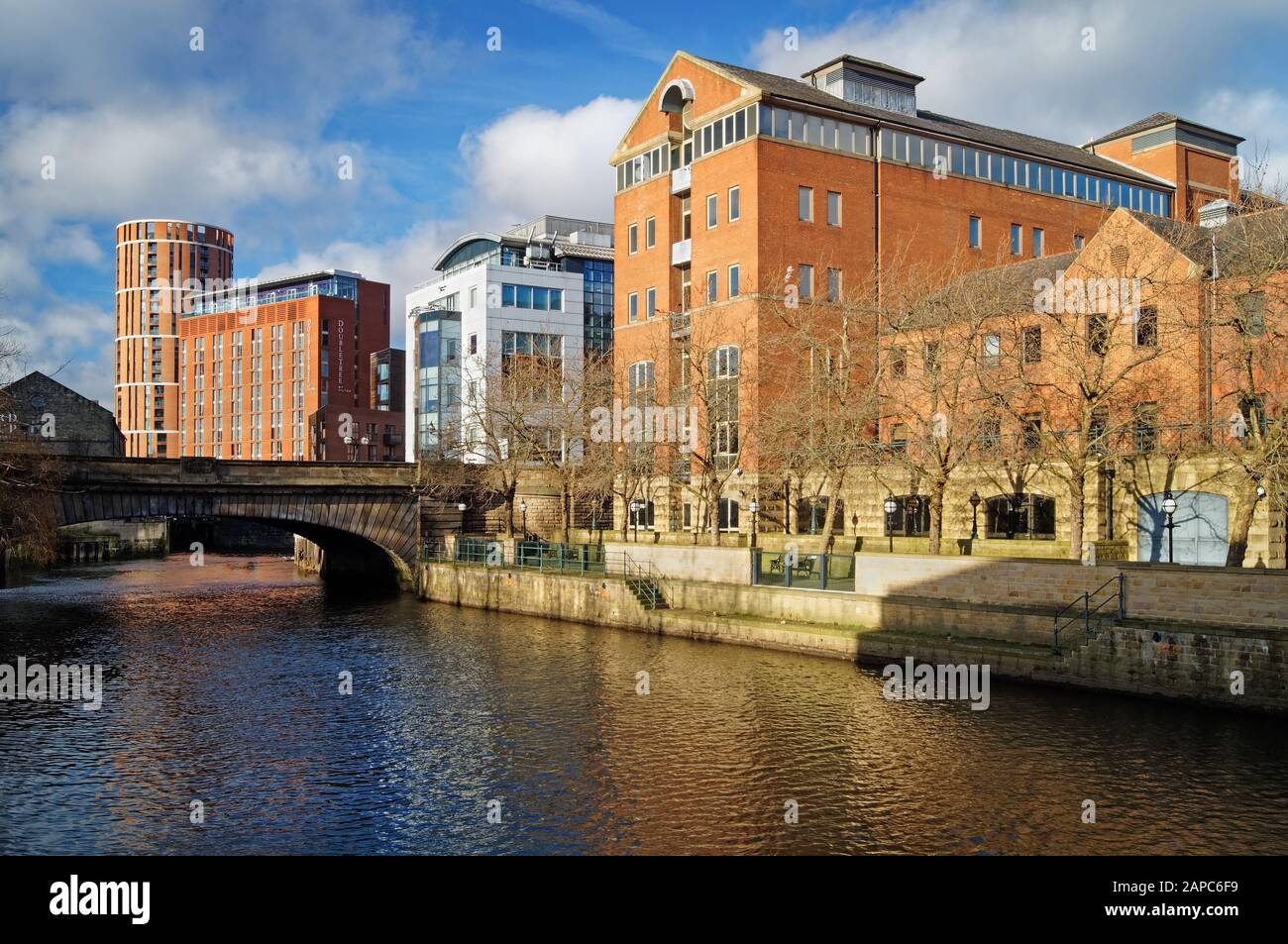 UK,West Yorkshire,Leeds,Victoria Bridge over the River Aire,surrounded by the Hilton Hotel,Office Buildings & Modern Waterfront Apartments. Stock Photo