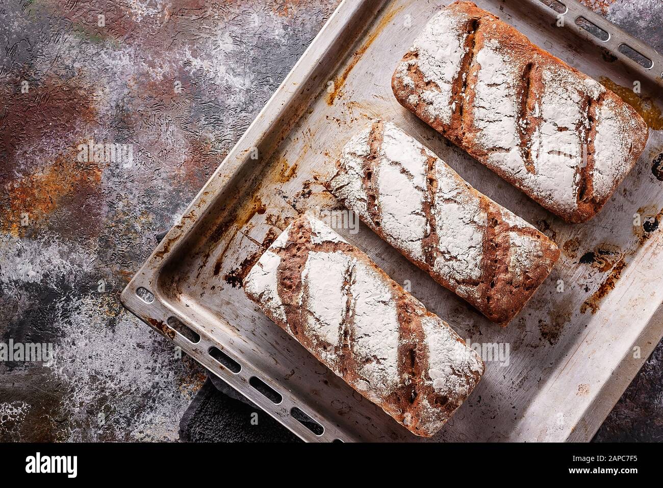 Top view freshly baked sourdough bread with sunflower and pumpkin seeds. Homebaked bread. Stock Photo