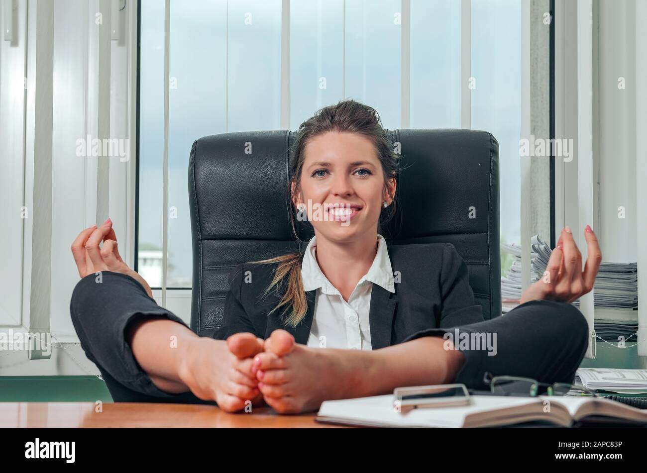 Closeup Image Of Businesswoman Resting Feet Under Desk Stock Photo, Picture  and Royalty Free Image. Image 100729228.