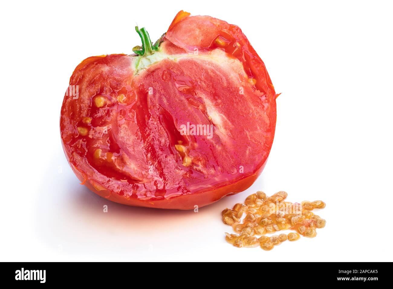 Process of manual tomato seeds extraction isolated on white Stock Photo
