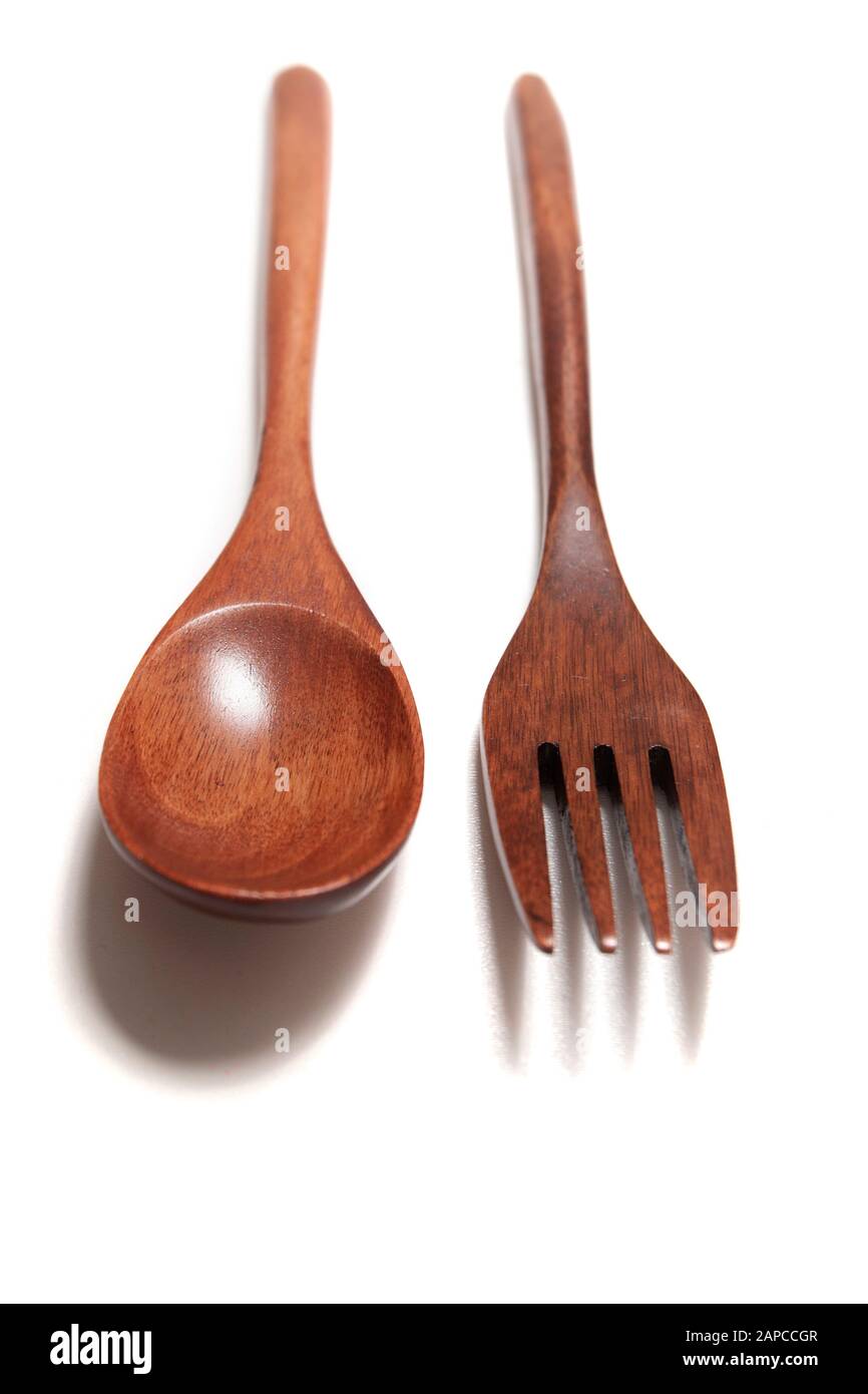 Close view of wooden fork and spoon over a white background Stock Photo