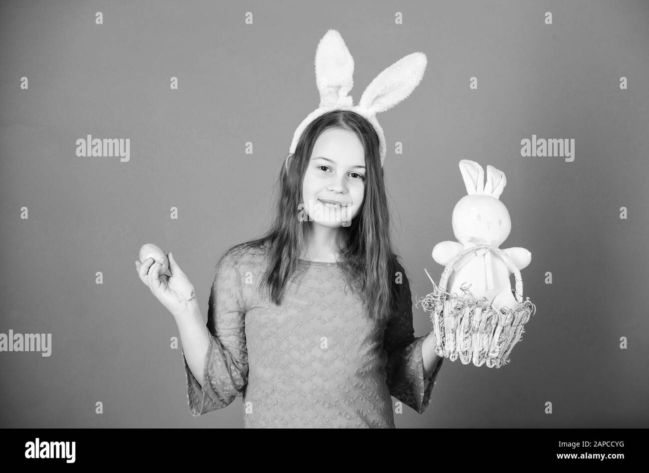 Easter egg hunts as part of festival. Girl little child easter bunny accessory hold dyed egg