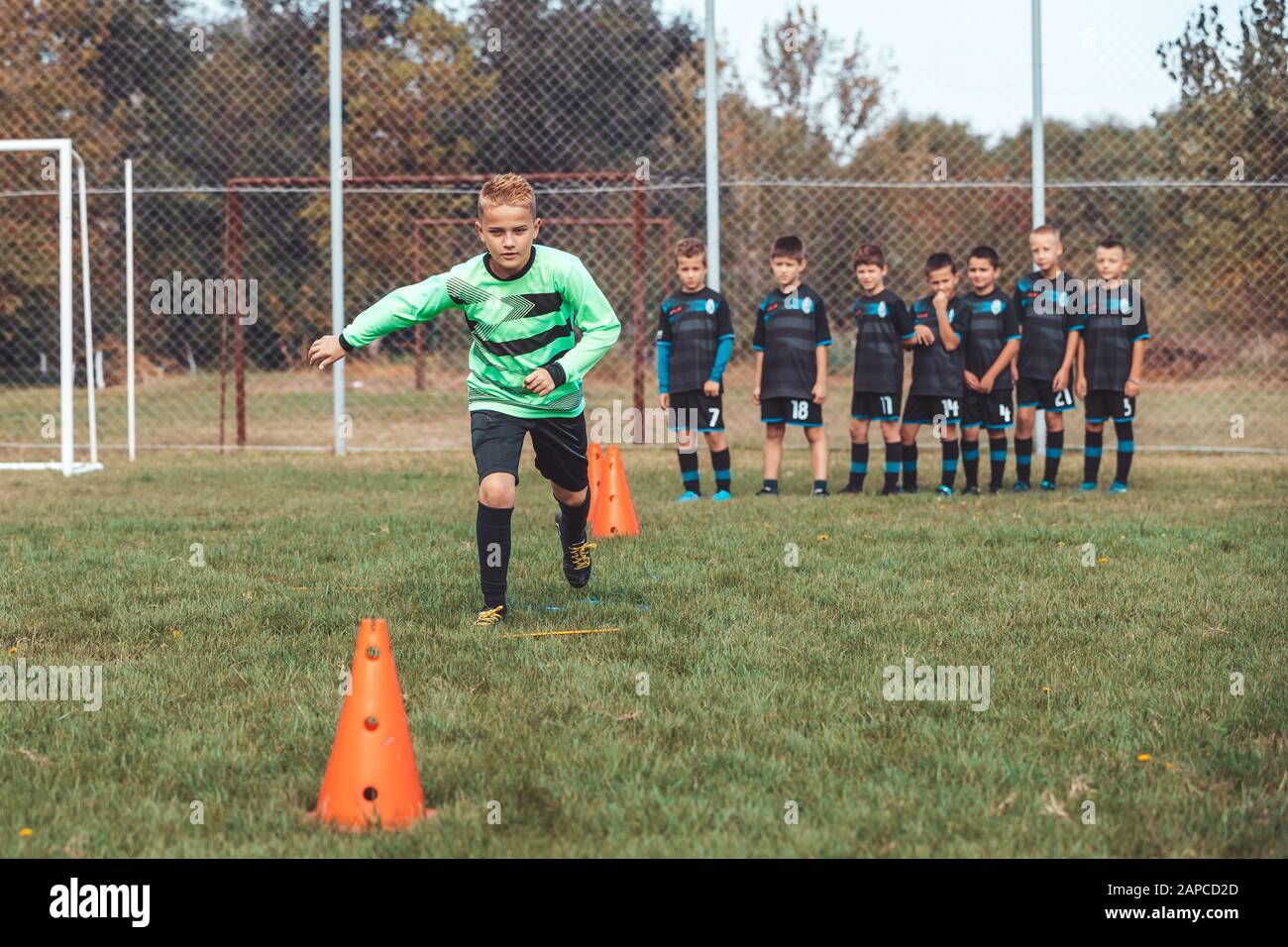 Soccer Drills The Slalom Drill Youth Soccer Practice Drills Young Football Player Training On Pitch Soccer Slalom Cone Drill Boy In Soccer Jerse Stock Photo Alamy