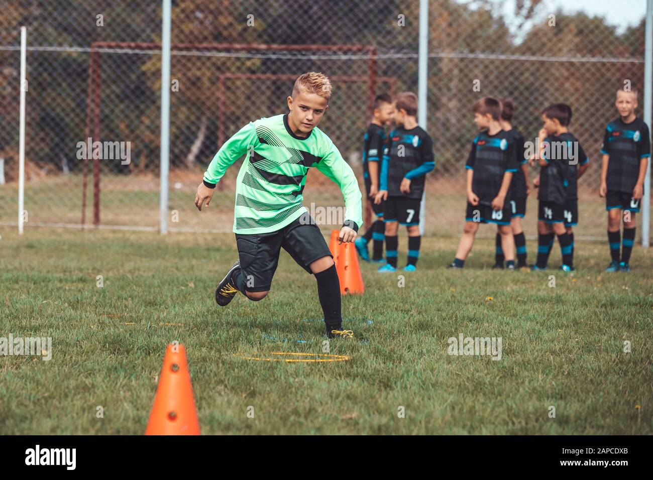 Soccer Drills The Slalom Drill Youth Soccer Practice Drills Young Football Player Training On Pitch Soccer Slalom Cone Drill Boy In Soccer Jerse Stock Photo Alamy