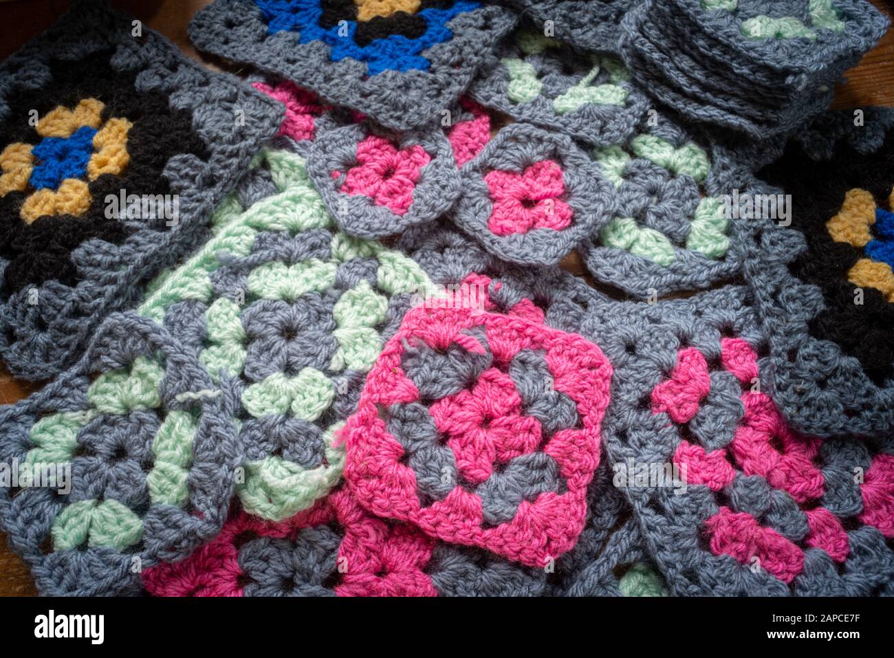 pile of different granny squares , in different colours . Stock Photo