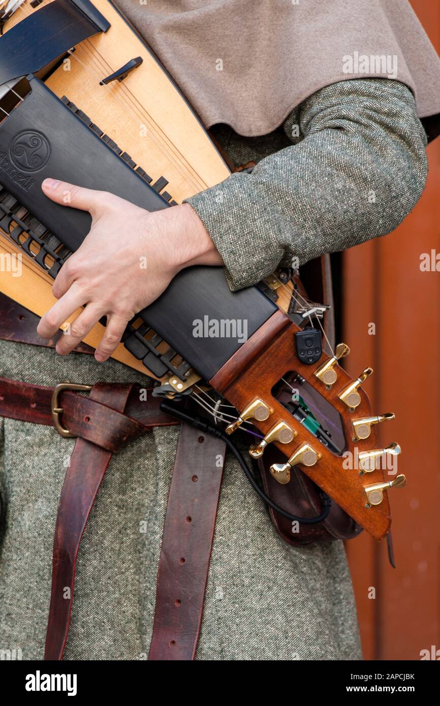 Medieval costume character band musician plays the hurdy-gurdy string  instrument Stock Photo - Alamy