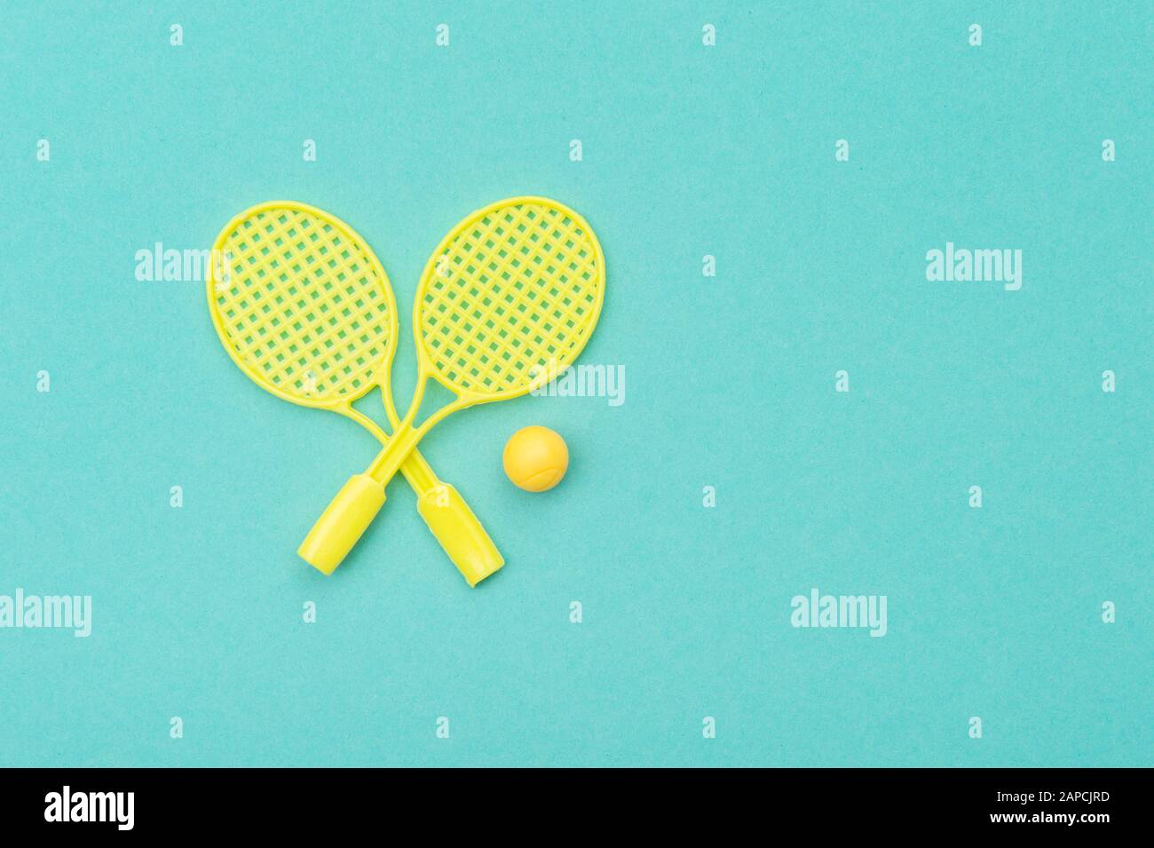 Tennis racket and ball sports on green background Stock Photo - Alamy