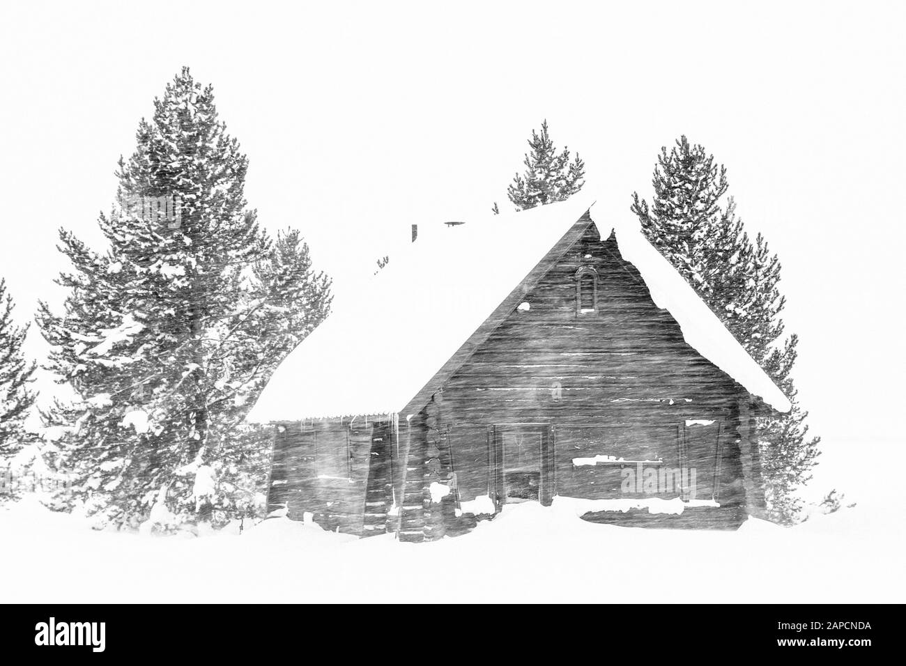 Old Log Cabin In A Classic Winter Snowy Field In Black And White