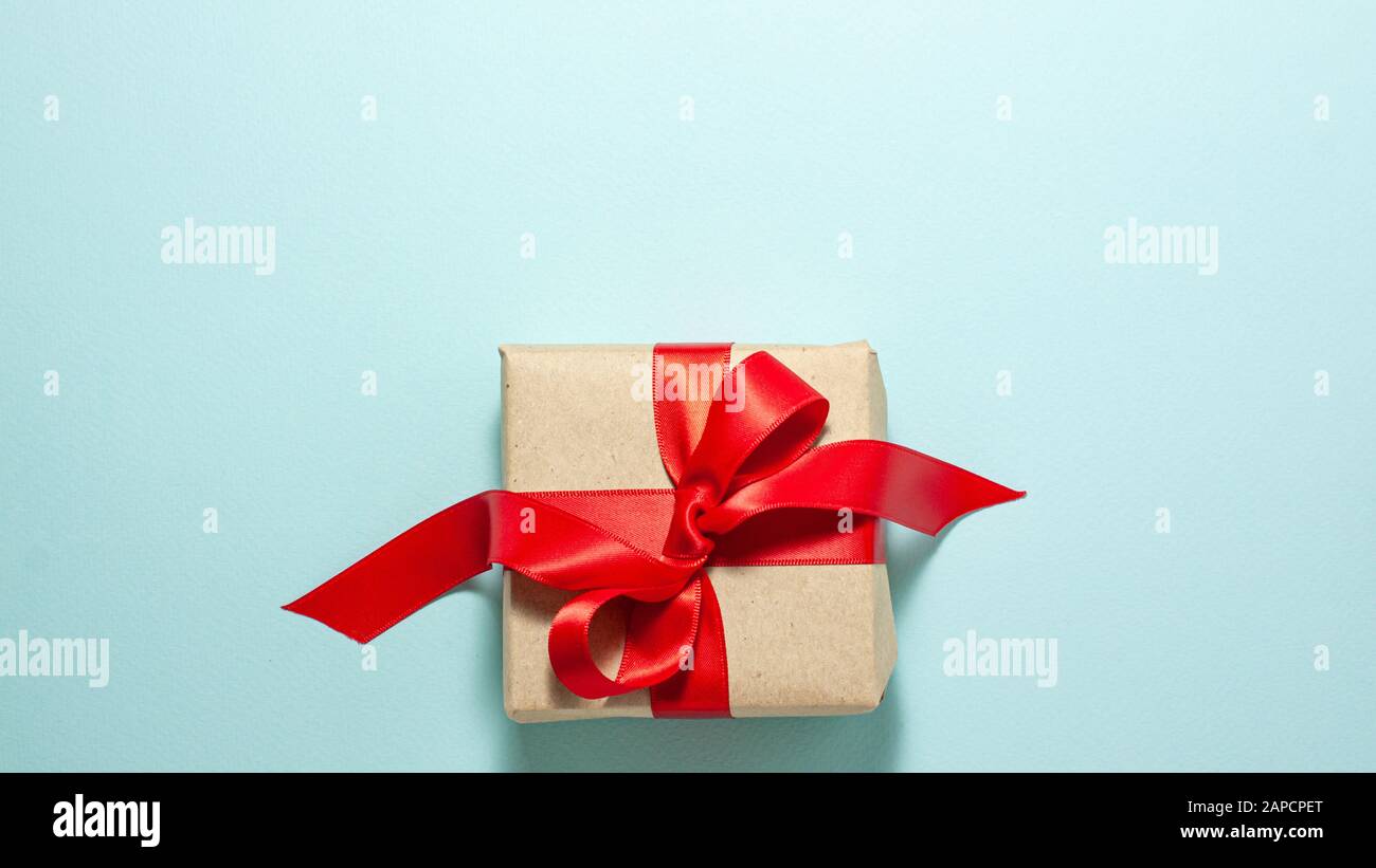 Banner Of Brown Paper Gift Box With A Red Satin Ribbon Bow At The