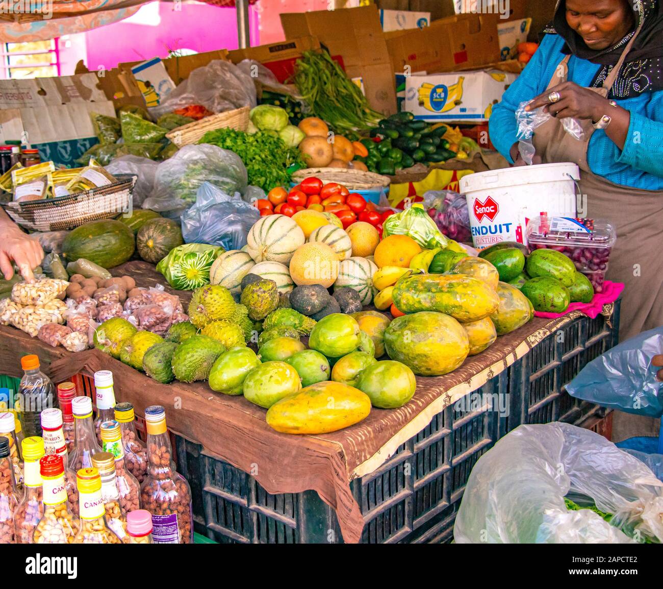 MBour, Senegal, AFRICA - April 22, 2019: Unidentified Senegalese woman selling fruits in her stall.Street fruit market where locals sell tropical Stock Photo