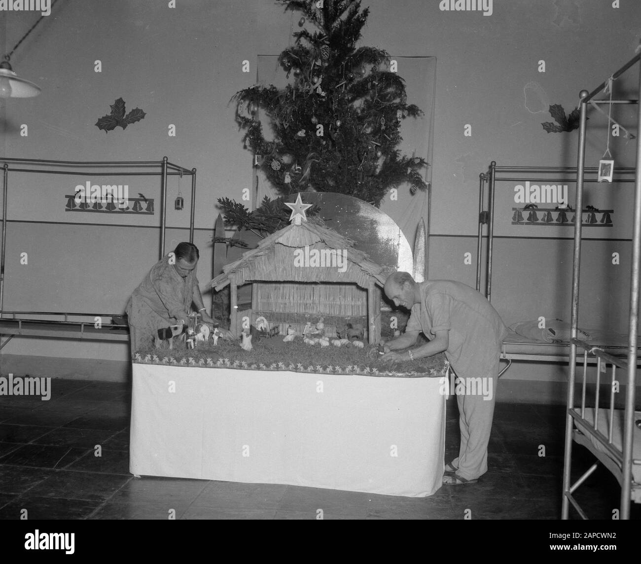 Nativity scene in Military Hospital I in Batavia Description: Adjutant Vasting and Sergeant V.D. Meulen made a Christmas manger in one of the halls of the Military Hospital I in Batavia. which attracted great attention by the artistic way in which this was composed. The army commander also came to take a look and expressed his admiration to the makers, that they had made a beautiful whole out of worthless material Date: 24 December 1947 Location: Batavia, Indonesia, Jakarta, Dutch East Indies Stock Photo