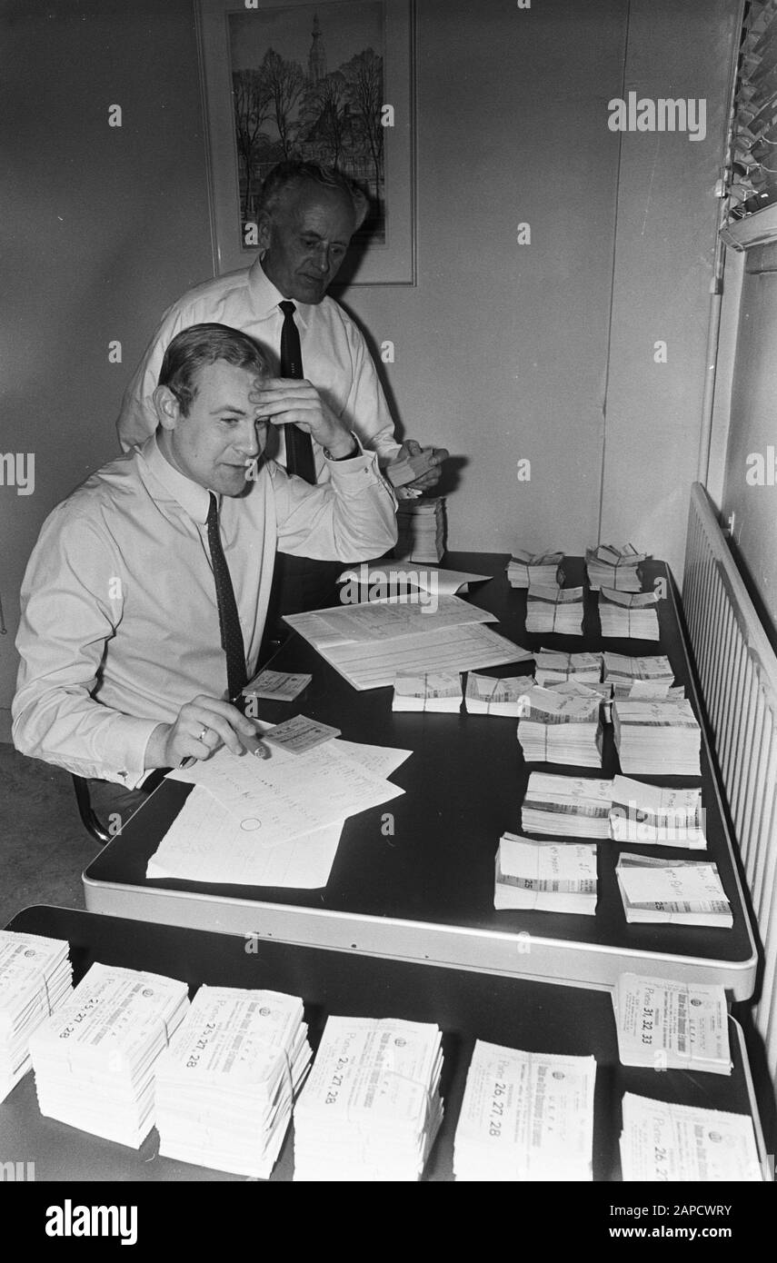 Administrator N. Dalmulder Ajax with W.F.C. Bruynestein with tickets for Ajax versus Benfica, at office Ajax Date: 26 February 1969 Location: Amsterdam, Noord-Holland Personal name: N. Dalmulder, W.f.c. Bruynestein Institution name: Benfica Stock Photo