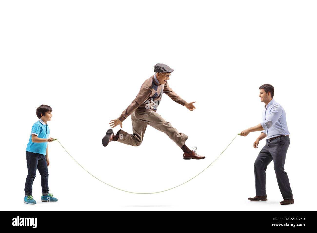 Full length profile shot of a father and boy holding a rope and a grandfather skipping isolated on white background Stock Photo