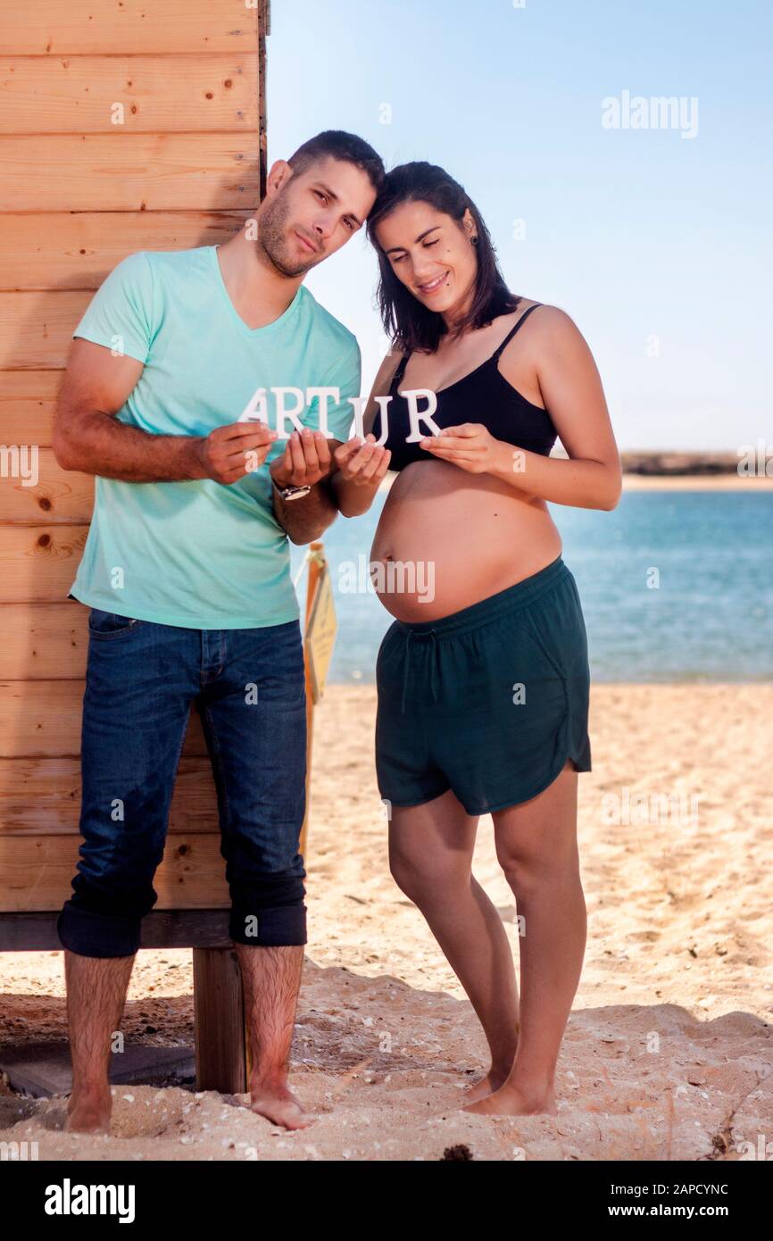 Pregnant Happy Couple With Name Letters On The Beach Stock Photo Alamy