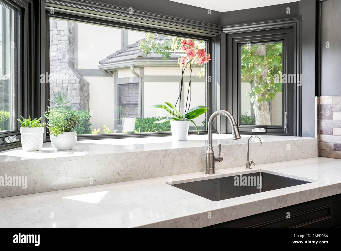 Kitchen counter and sink with large window Stock Photo
