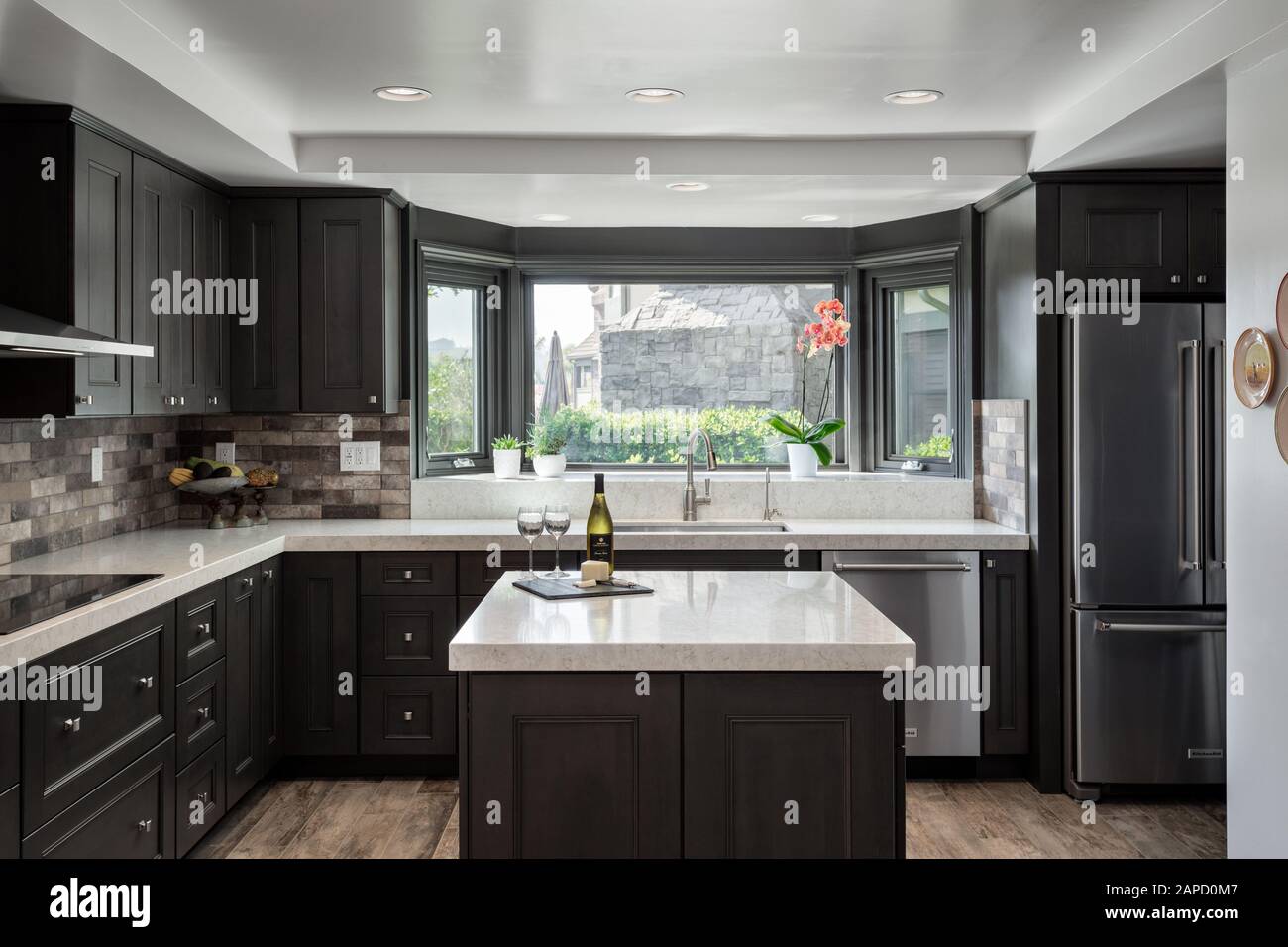 Remodeled kitchen with dark cabinets and island Stock Photo