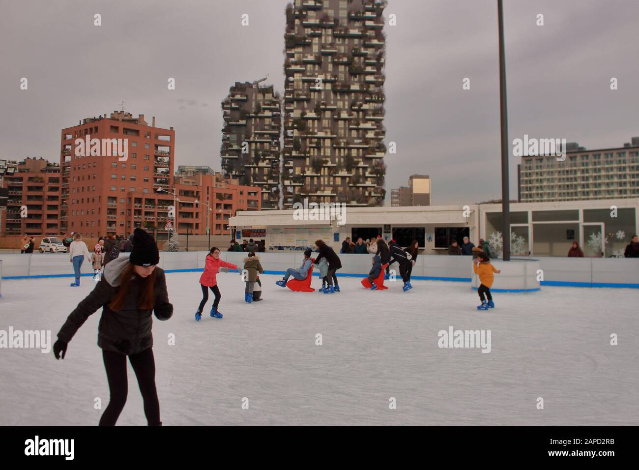ice skating in the Porta Nuova financial district of Milan (Italy). In the cityscape the world famous vertical forest skycrapers. Stock Photo