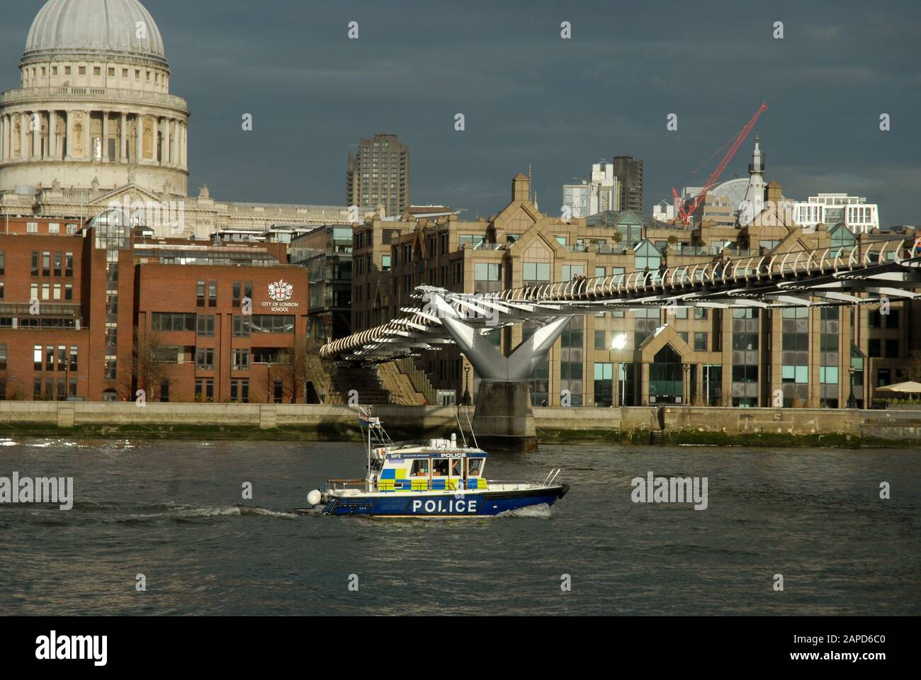 A police launch belonging to the Marine Support Unit of the Metropolitan Police on the River Thames under the Millennium Bridge, London, UK Stock Photo