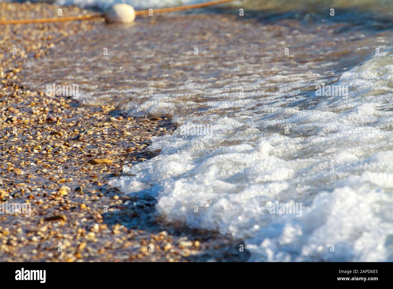 Sea waves with white foam on the seashore. Summer beach of the warm sea ...