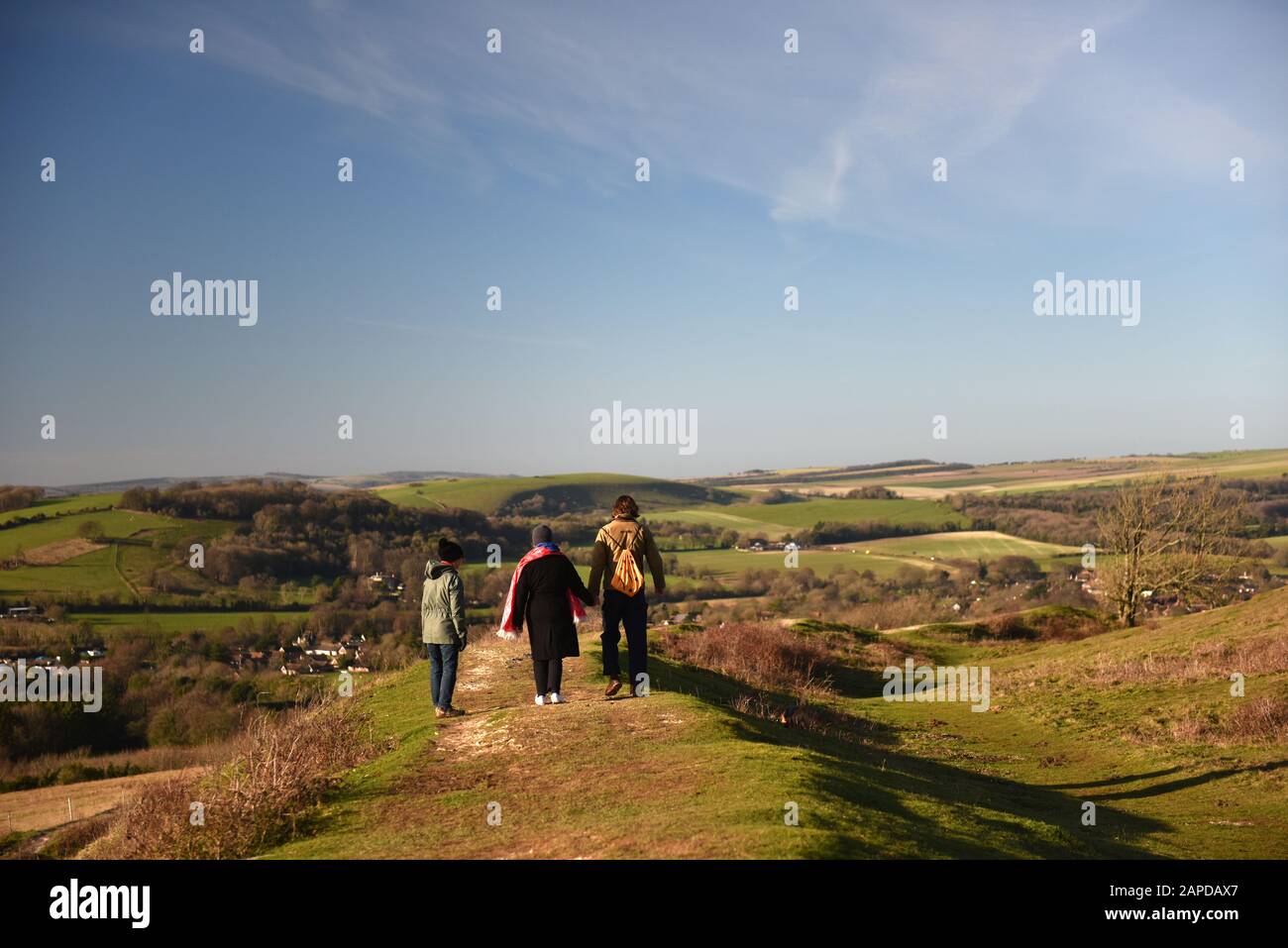 A family walking on Cissbury Ring, Worthing, West Sussex, UK Stock Photo