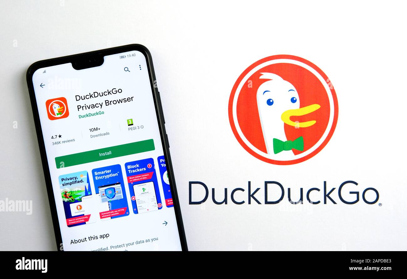 DuckDuckGo privacy browser app on the screen of smartphone placed on the brochure with DuckDuckGo logo. Real photo, not a montage. Stock Photo