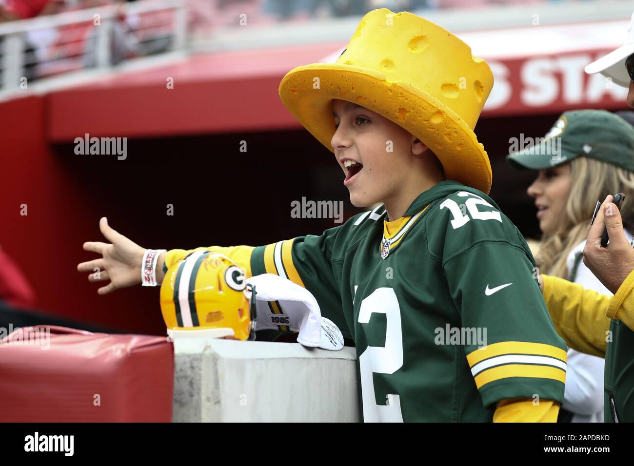 A San Francisco 49ers fan sports a Super Bowl ring hat and holds a