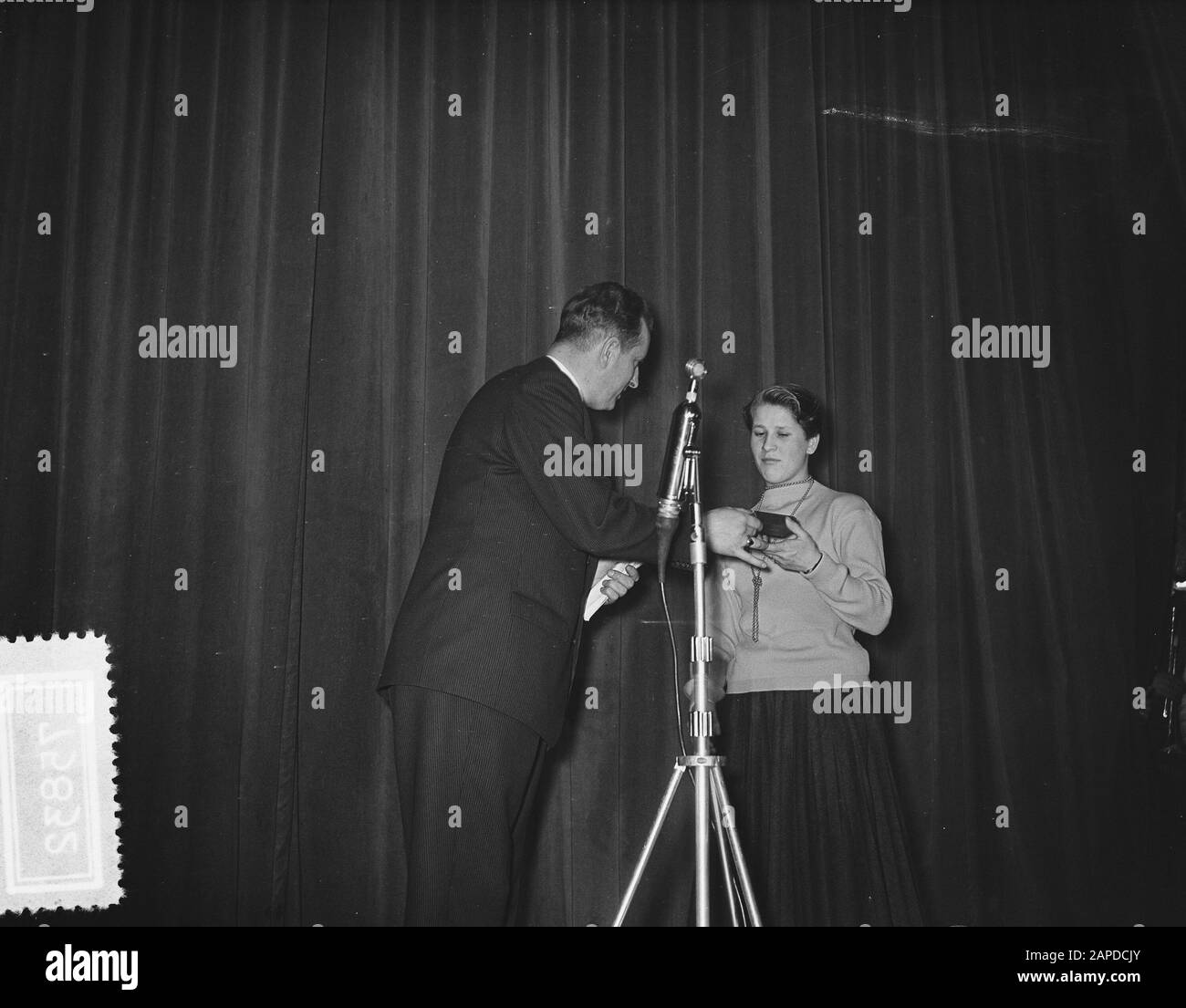 AVRO election Sportsman of the year 1955. Swimmer Lenie de Nijs (4th place) is awarded an award by Mr. D. Repko, director of the AVRO Annotation: There was no distinction between male and female athletes at the time. There was only 1 category Date: 8 February 1956 Location: Amsterdam Keywords: awards, athletes, sports awards Personal name: Nijs, Lenie de, Repko, D. Institution name: AVRO Stock Photo