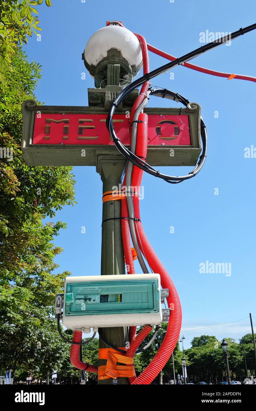 Metro sign with power cables - Champs-Élysées - Clemenceau, metropolitan train station sign, Paris,France, Stock Photo
