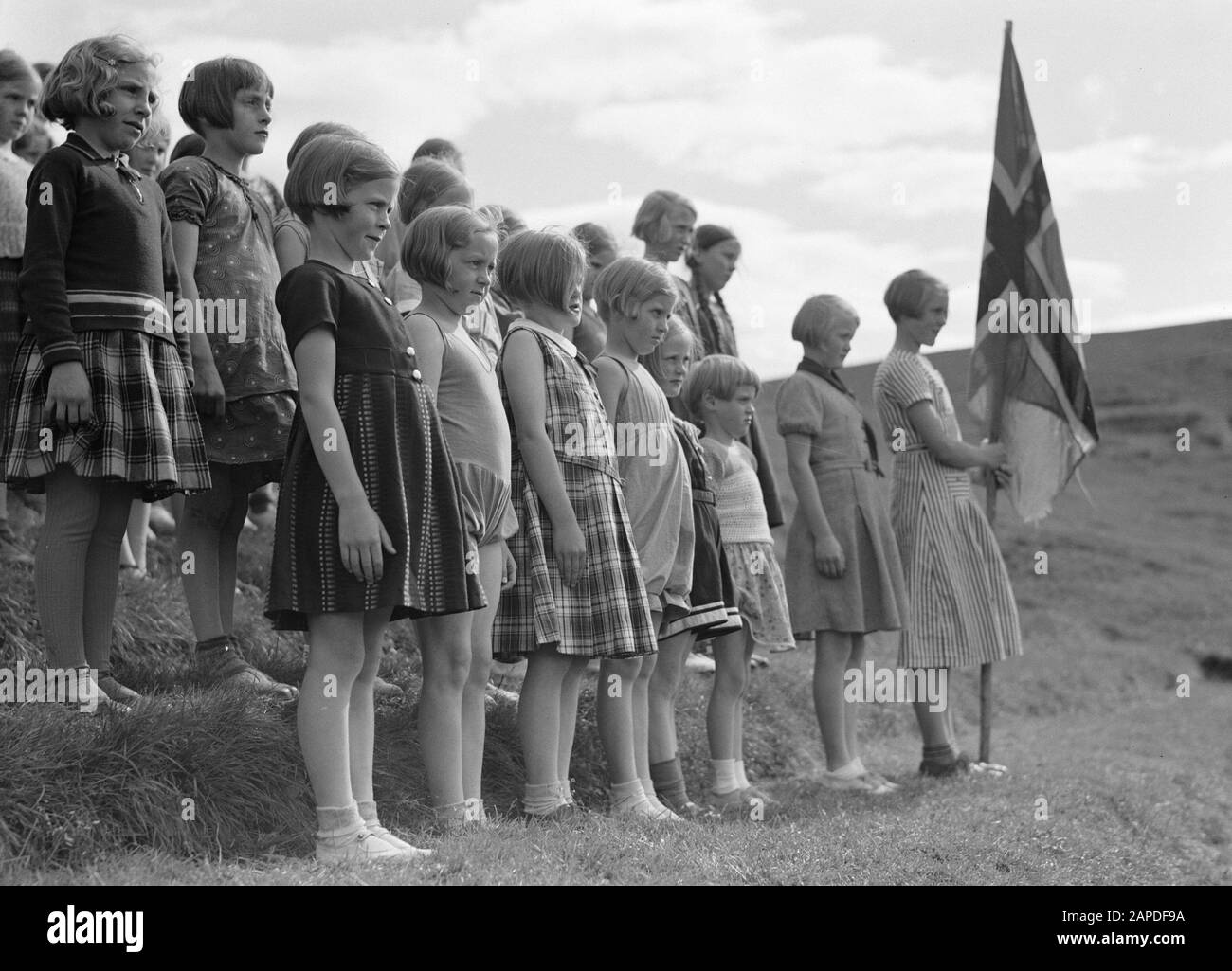 Iceland Description: Alafoss. Young girls, one of whom bearing the Icelandic flag, are lined up in line on the steps of an amphitheater Date: 1934 Location: Iceland, Àlafoss Keywords: amphitheatres, girls, ceremonies, flags Stock Photo