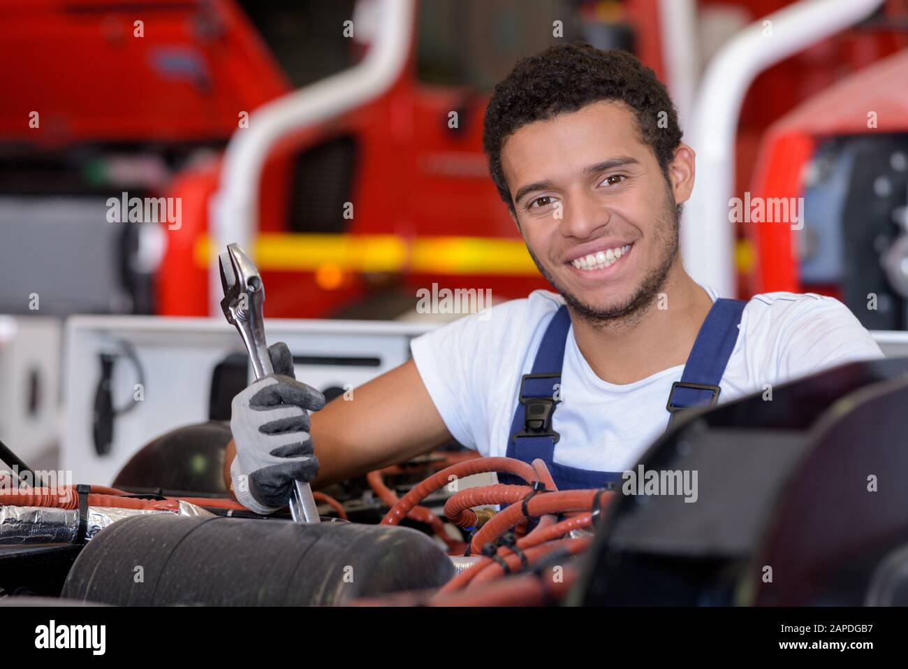 young heavy equipment mechanic smiling Stock Photo Alamy