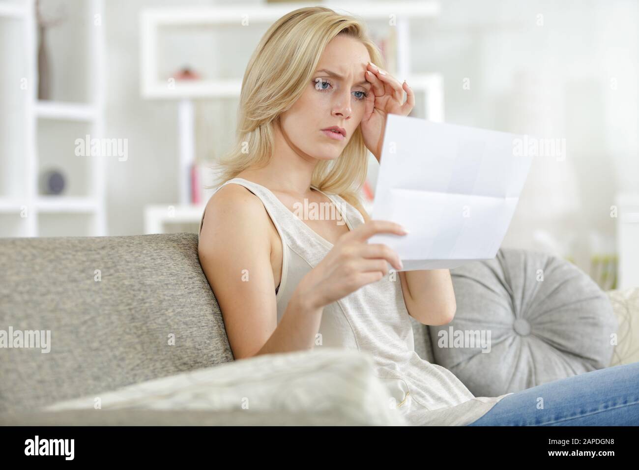 young attractive woman received company upsetting notice letter Stock Photo