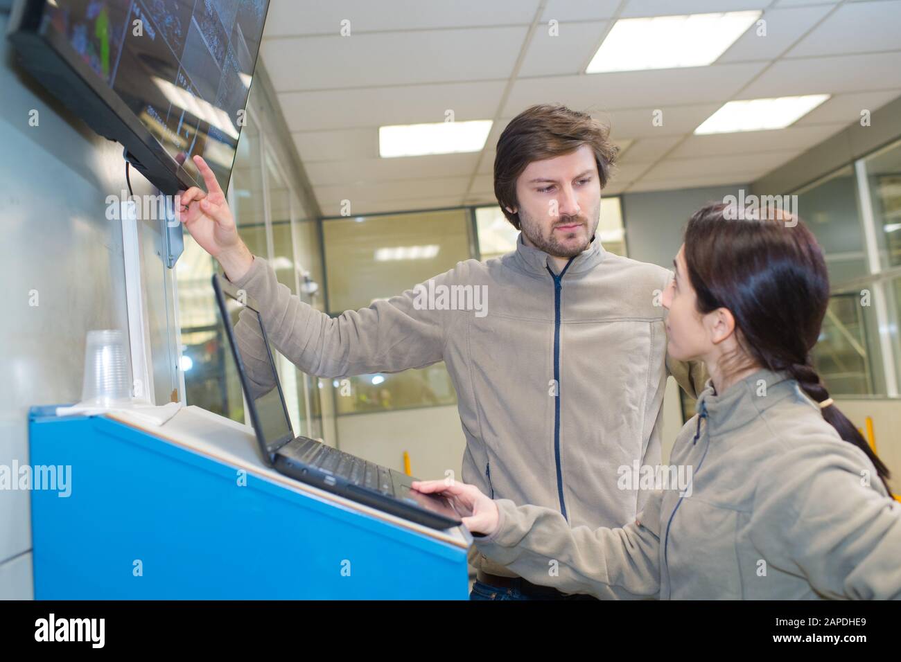Male factory workers operating industrial equipment hi-res stock ...