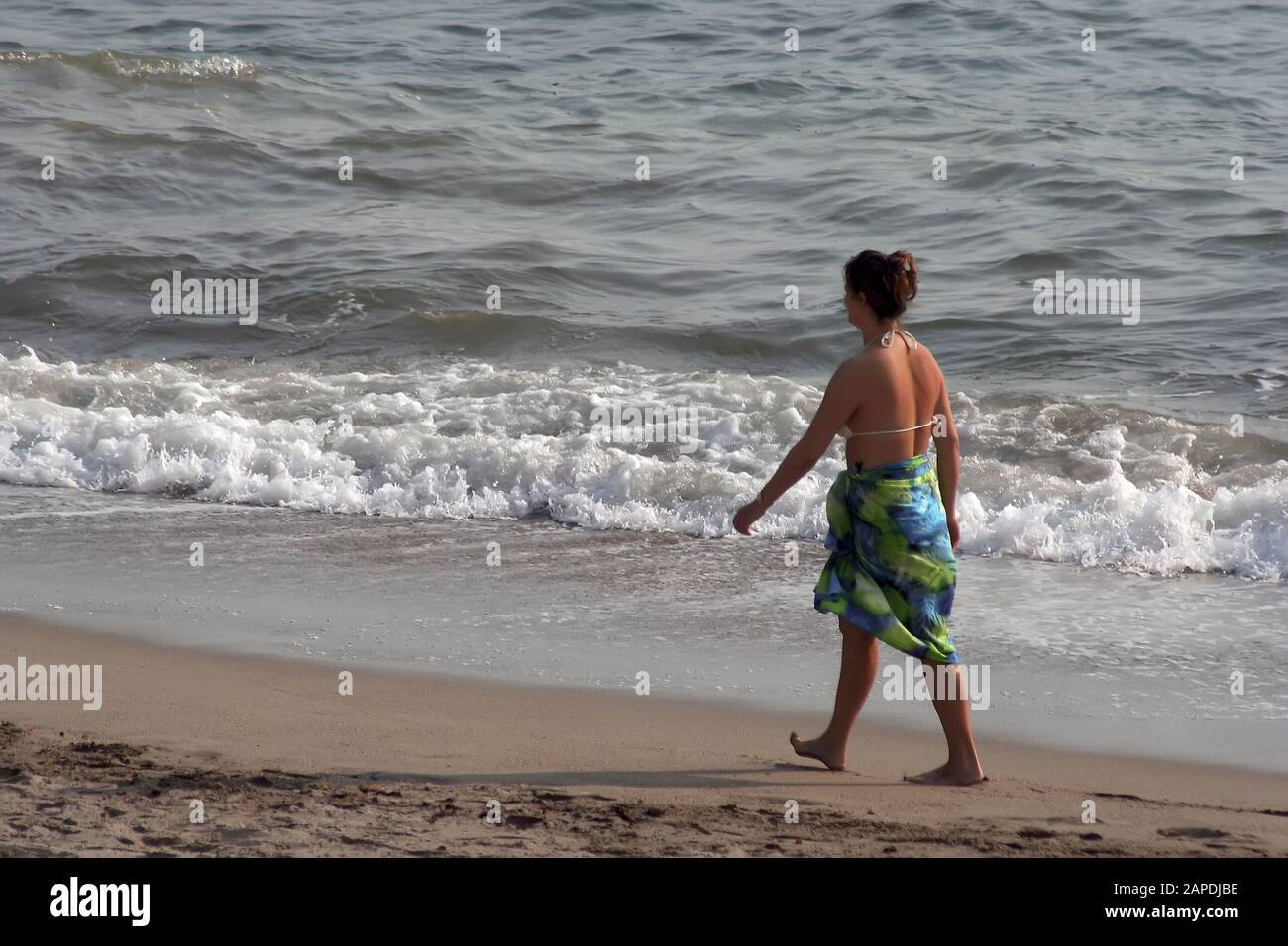 woman walking on beach Stock Photo
