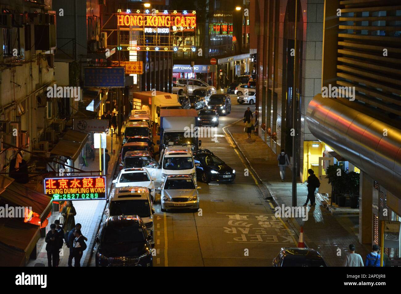 Looking down at traffic and pedestrians on Jaffe Road after dark in the trendy Wan Chai neighborhood of Hong Kong. Stock Photo