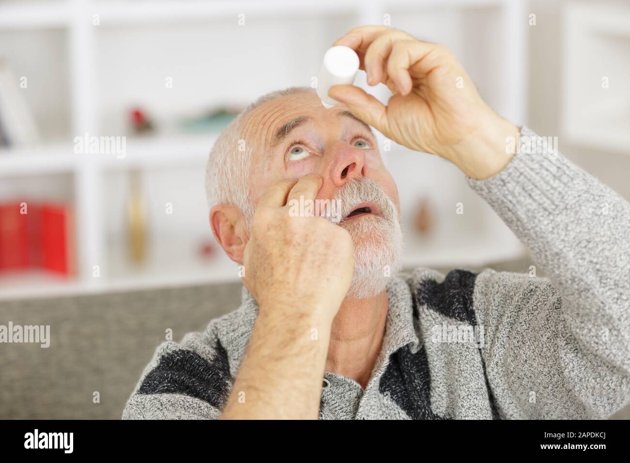 elderly person using eye drops Stock Photo Alamy