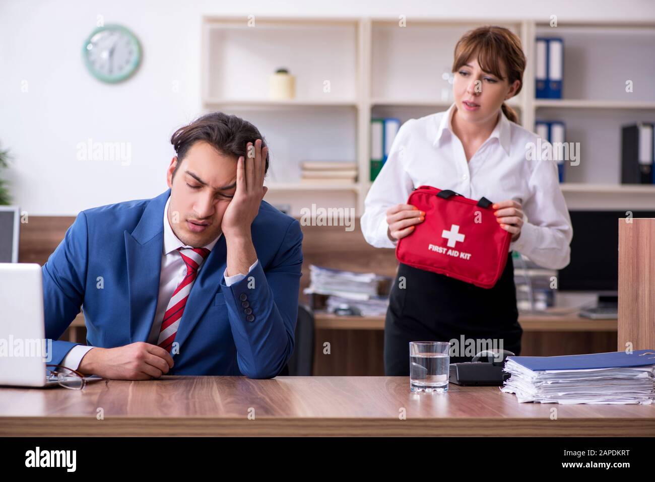 Employee receiving first aid in office Stock Photo - Alamy