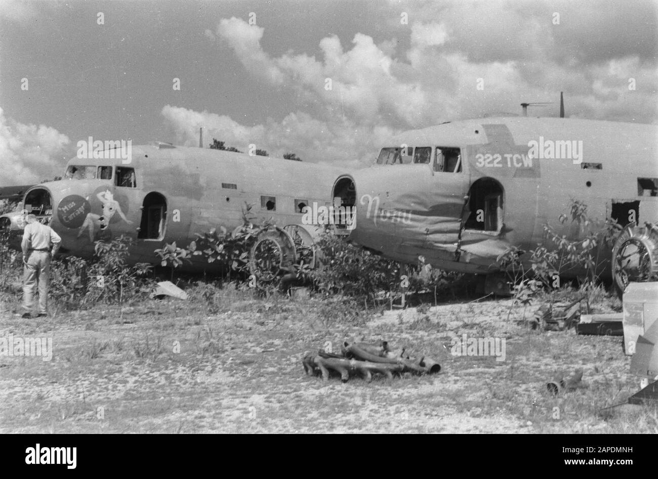 Great East Description: [American aircraft cemetery with Douglas C-47 Dakota aircraft] Annotation: To read are the names Miss Carriage and Nomi. and registration number 322 TCW Date: 10 November 1947 Location: Indonesia, Dutch East Indies Stock Photo