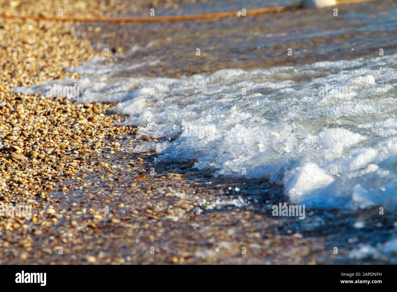 Sea waves with white foam on the seashore. Summer beach of the warm sea ...