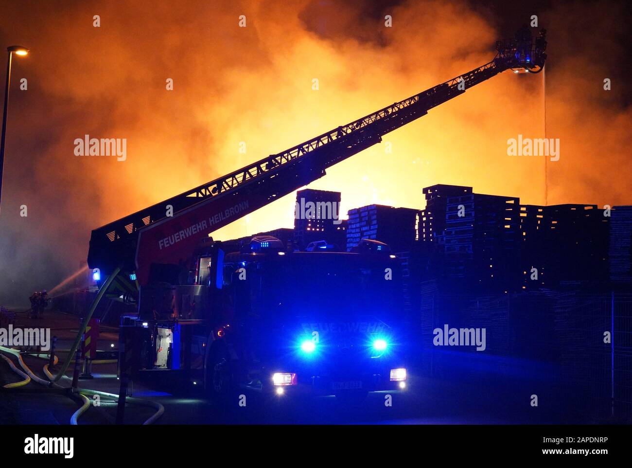 Ilsfeld, Germany. 22nd Jan, 2020. Firefighters try to extinguish stacks