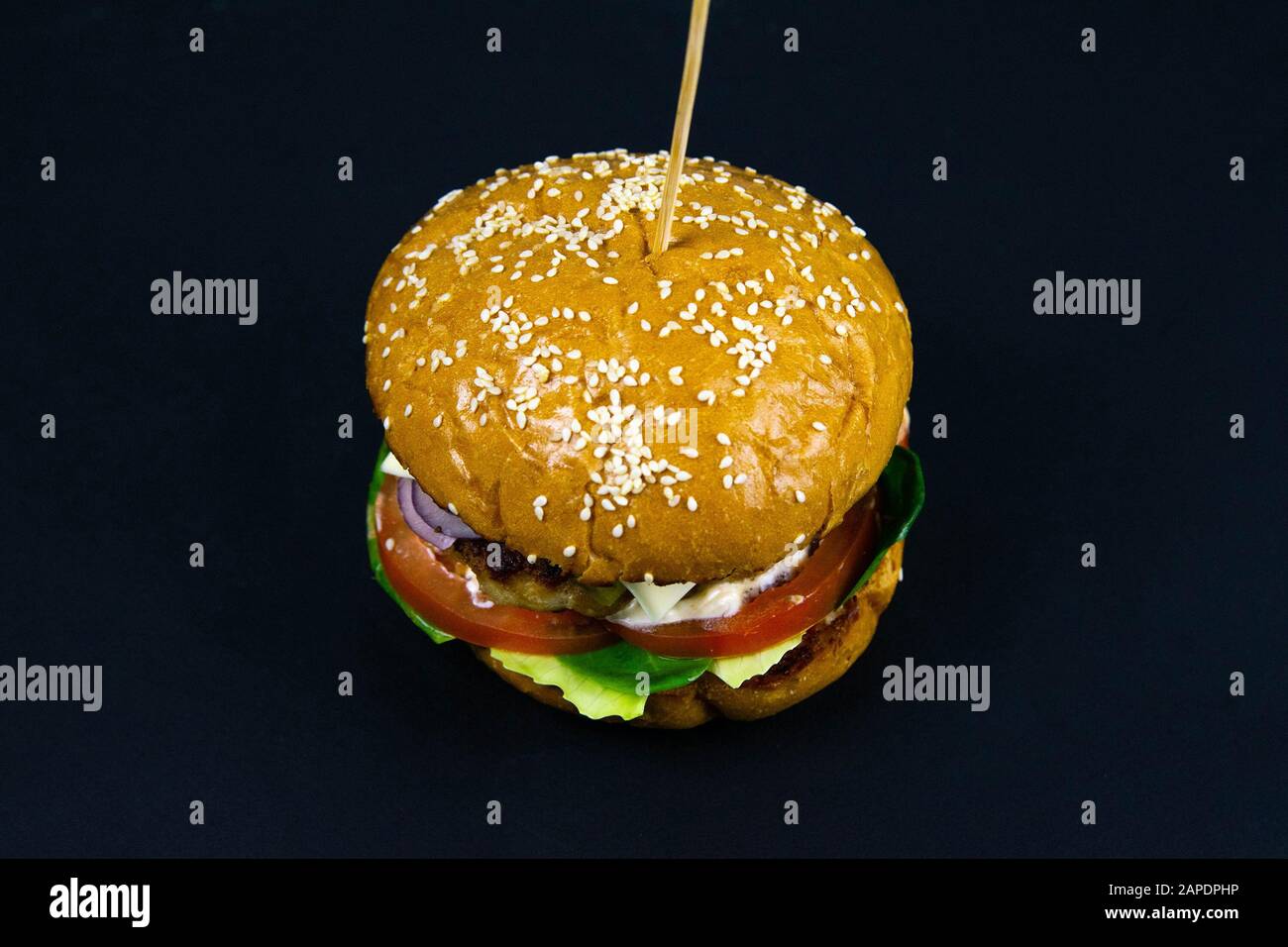 Fresh tasty burger on black background front views Stock Photo