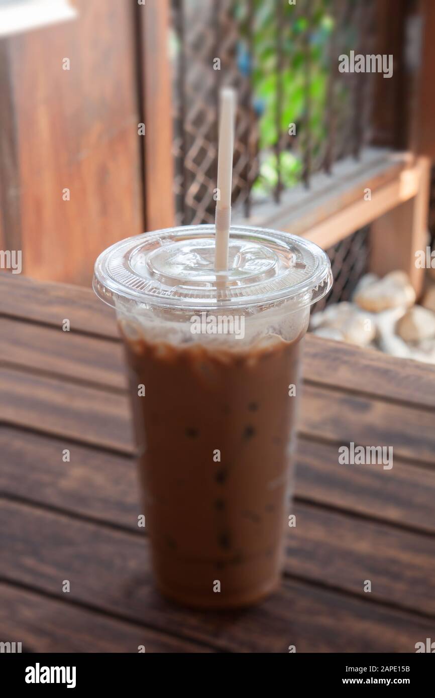 Iced coffee in coffee shop on wooden table, stock photo Stock Photo