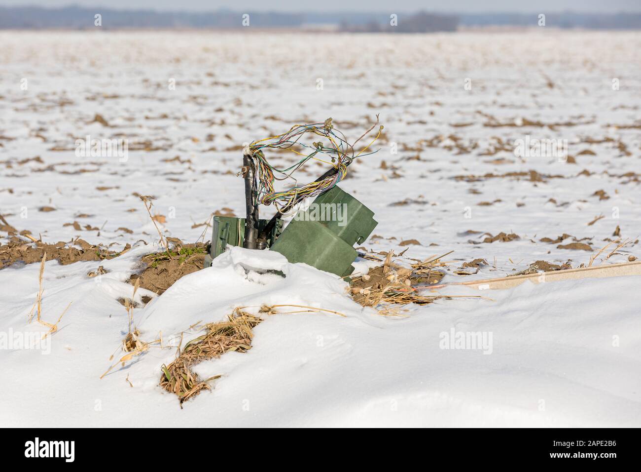 Telephone pedestal junction box damaged with exposed wires in ditch. Concept of rural telephone and internet access, repair, outage, and service Stock Photo